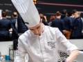 Franco-putting-ingredient-in-small-pot
